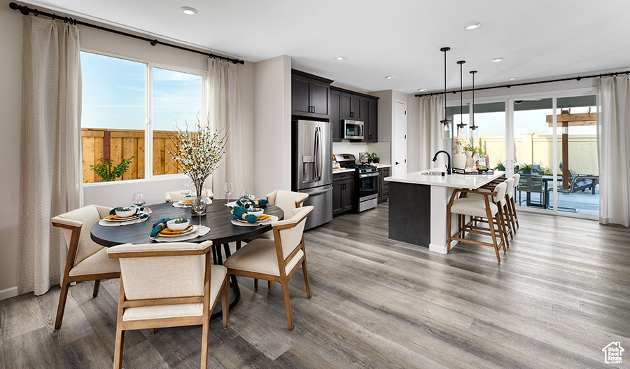 Dining room featuring light wood-type flooring and recessed lighting