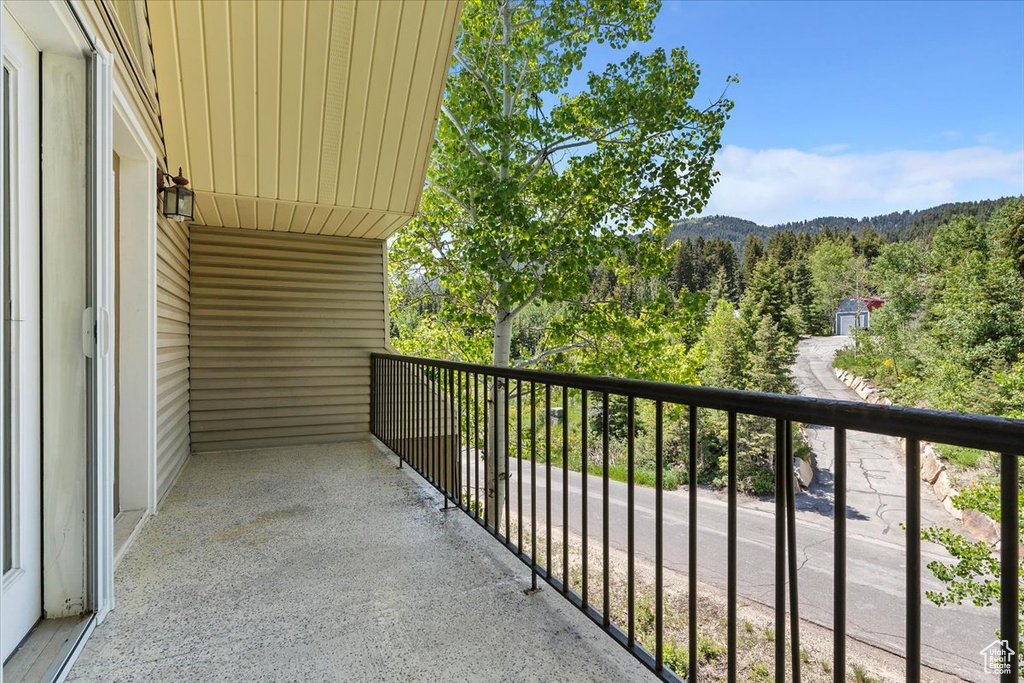 Balcony featuring a forest view