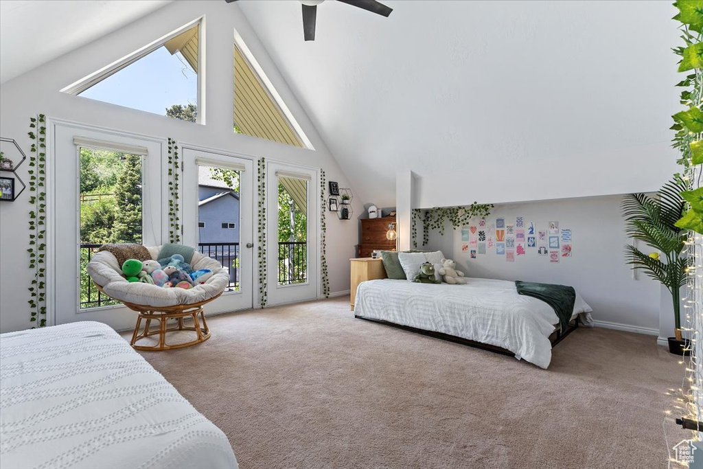 Bedroom with access to outside, carpet flooring, a ceiling fan, and high vaulted ceiling