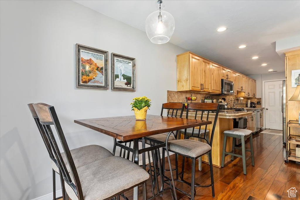 Dining room featuring dark wood-style flooring and recessed lighting