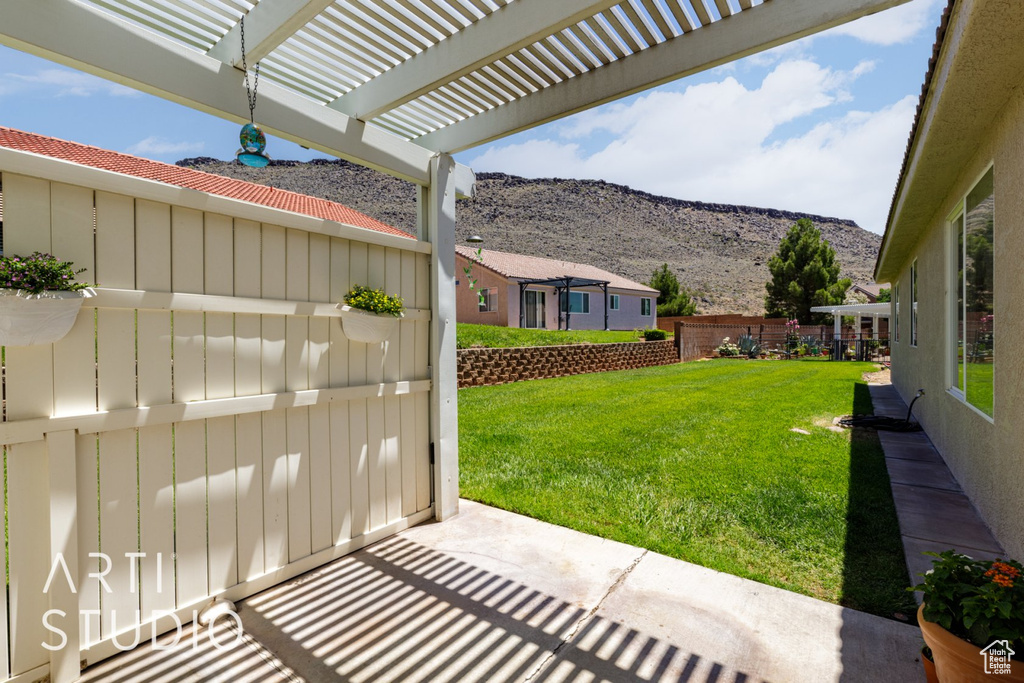 View of yard with a mountain view and a pergola