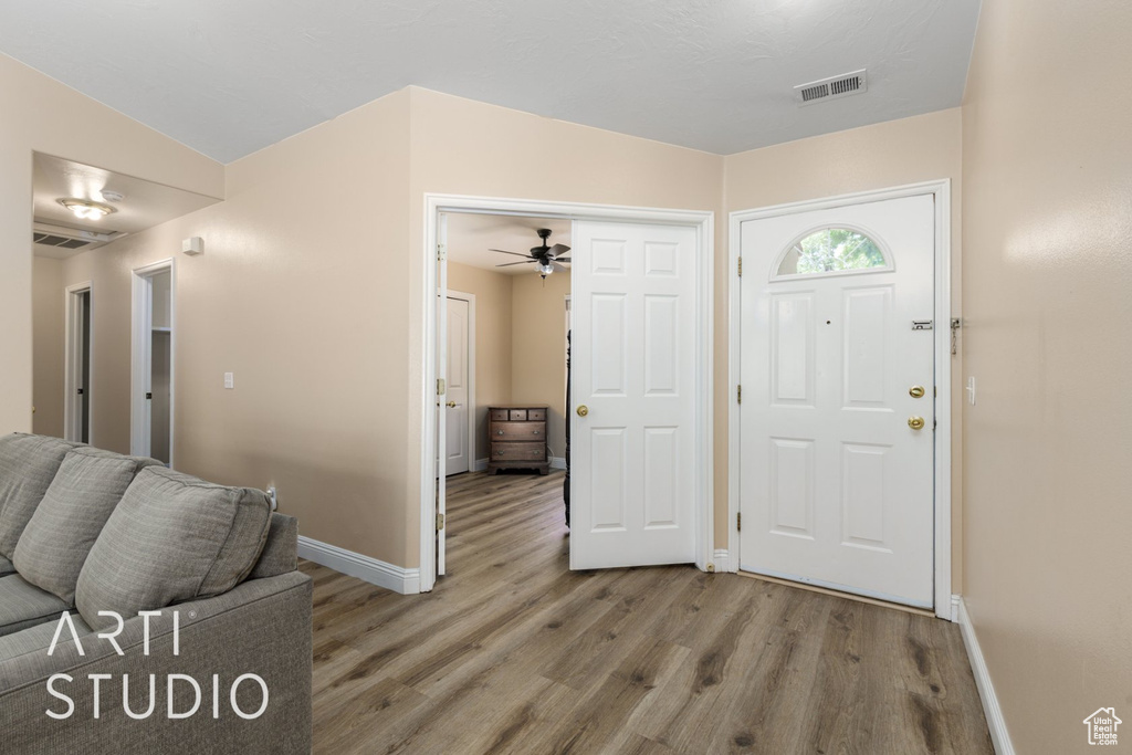 Foyer with wood finished floors, baseboards, and ceiling fan