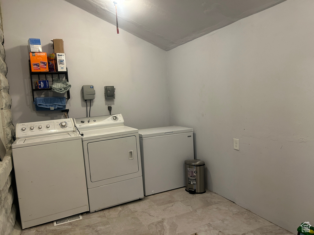 Washroom with washer and clothes dryer