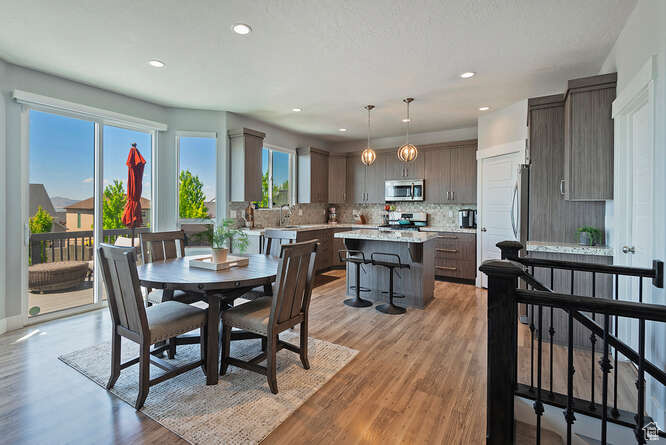 Dining room featuring light wood-type flooring and recessed lighting