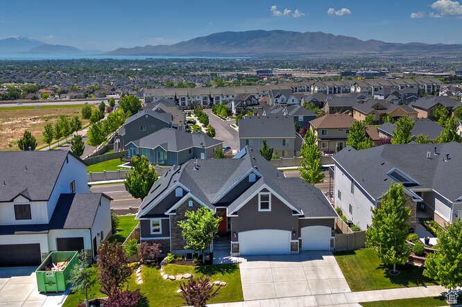 Aerial perspective of suburban area featuring a mountainous background