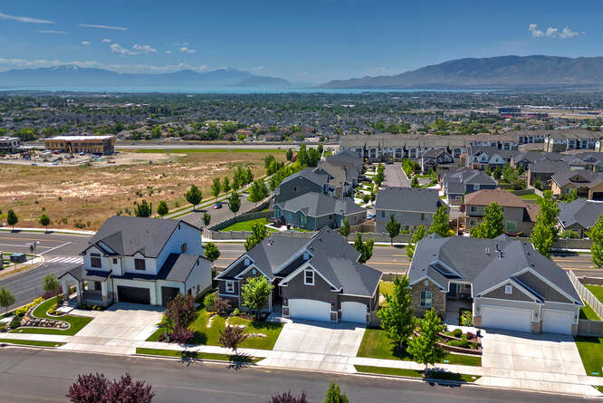 Aerial perspective of suburban area with a mountainous background