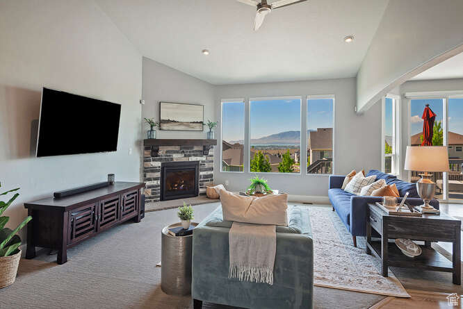 Living room with lofted ceiling, a fireplace, and recessed lighting