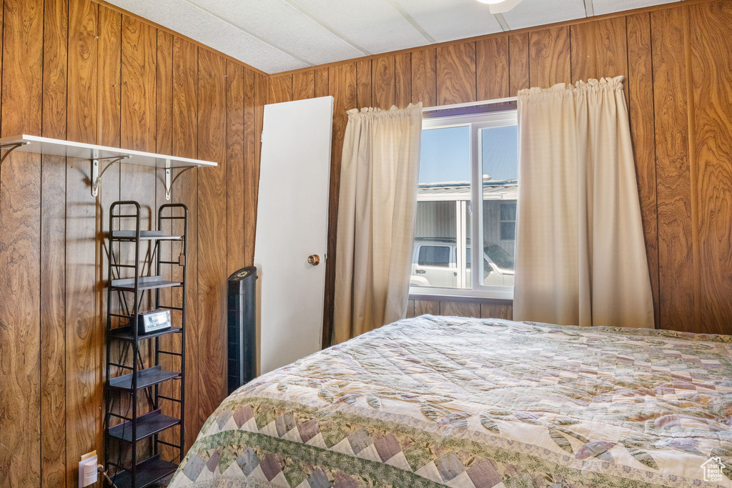 Bedroom featuring wood walls