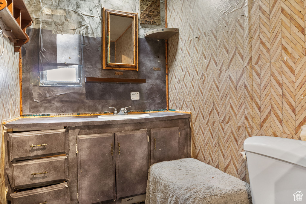 Half bathroom with vanity and toilet