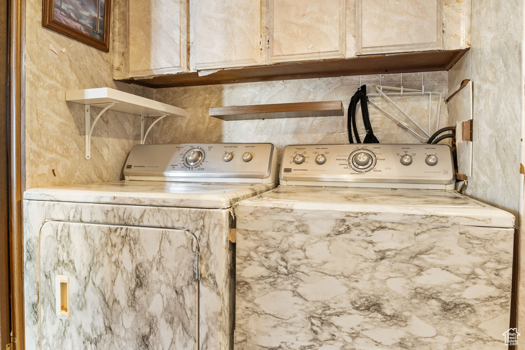 Laundry room featuring washer and dryer and cabinet space