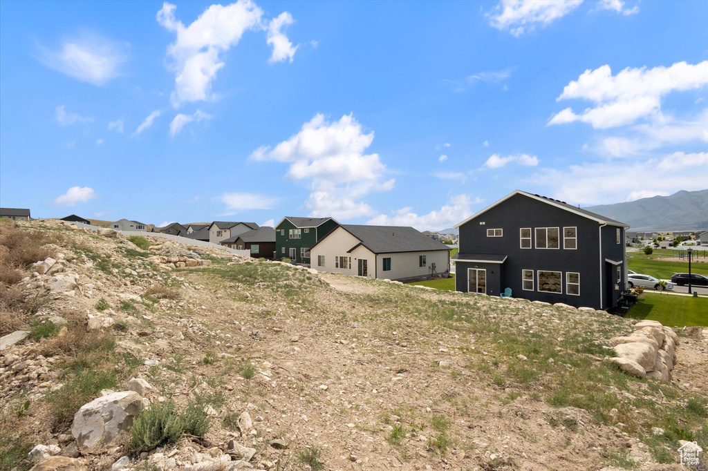 Back of property with a residential view and a mountain view