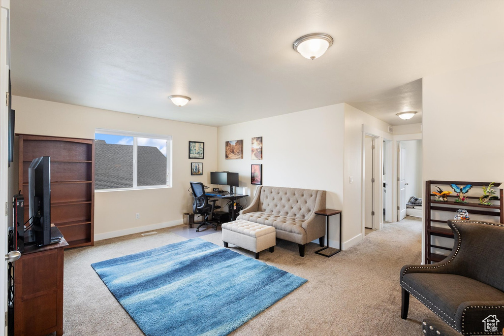 Living room featuring carpet flooring and an office area