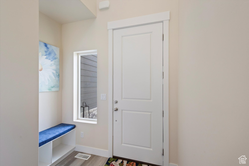 Mudroom with wood finished floors and baseboards
