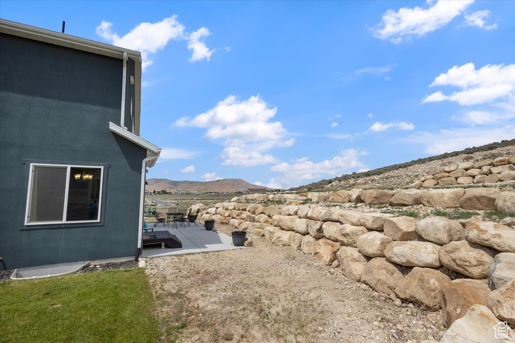 View of yard with a deck with mountain view