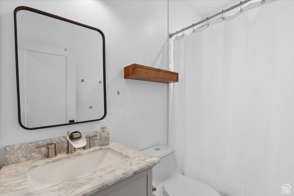 Bathroom featuring vanity and curtained shower