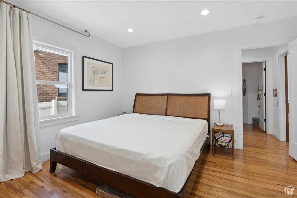 Bedroom with light wood finished floors and recessed lighting