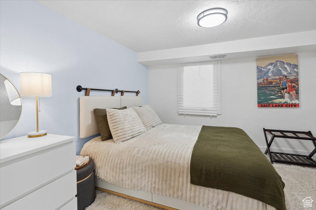 Bedroom with light carpet