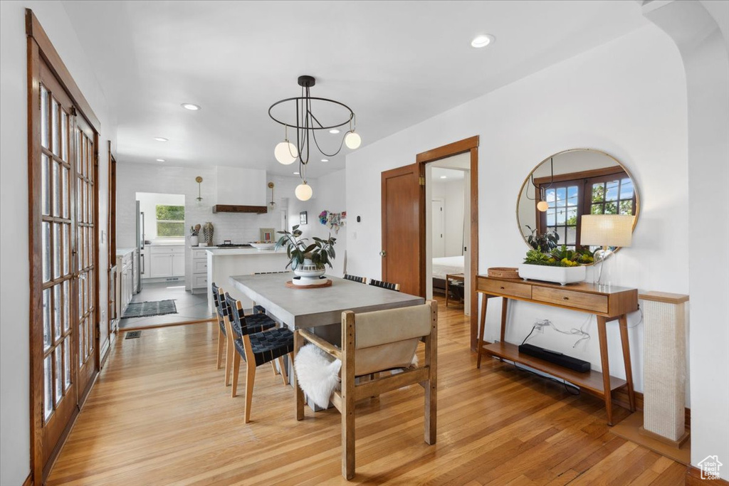 Dining room with light wood-type flooring, plenty of natural light, and recessed lighting