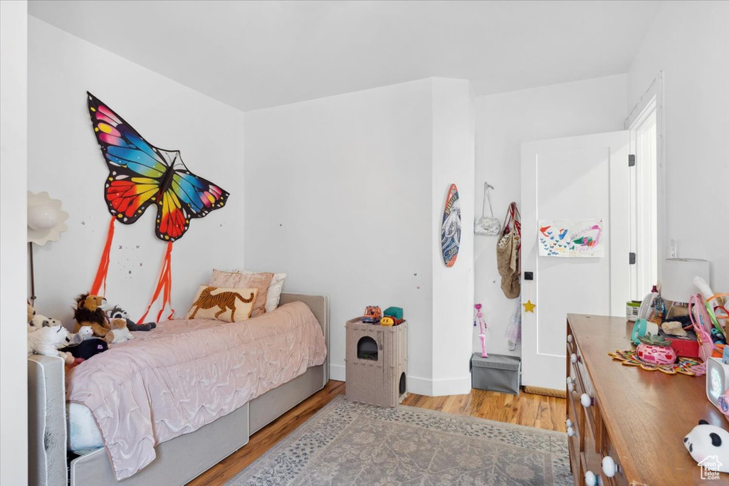 Bedroom featuring light wood-style flooring and baseboards