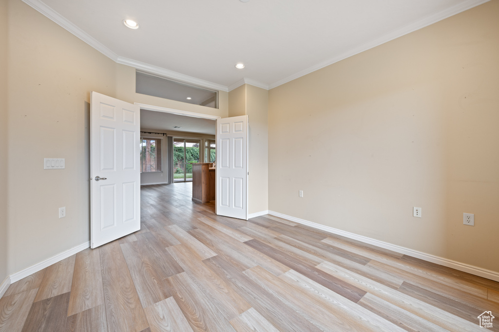 Unfurnished room with recessed lighting, light wood-style floors, and ornamental molding