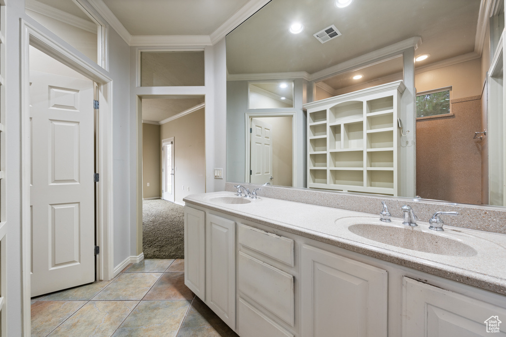 Full bathroom with crown molding, double vanity, recessed lighting, a closet, and tile patterned floors