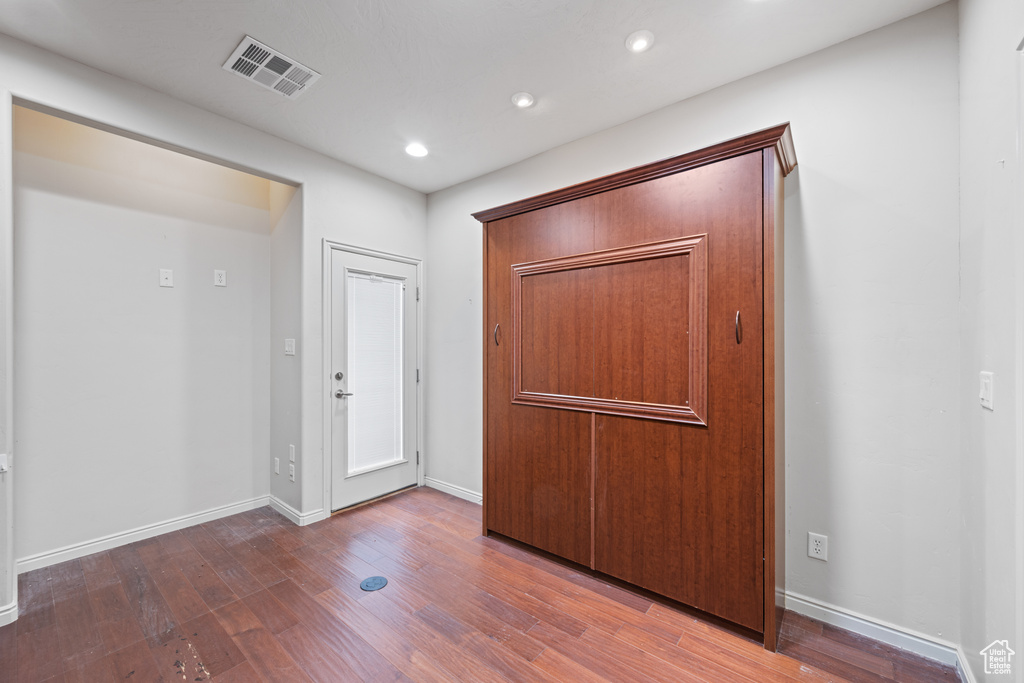 Entrance foyer with wood finished floors and recessed lighting