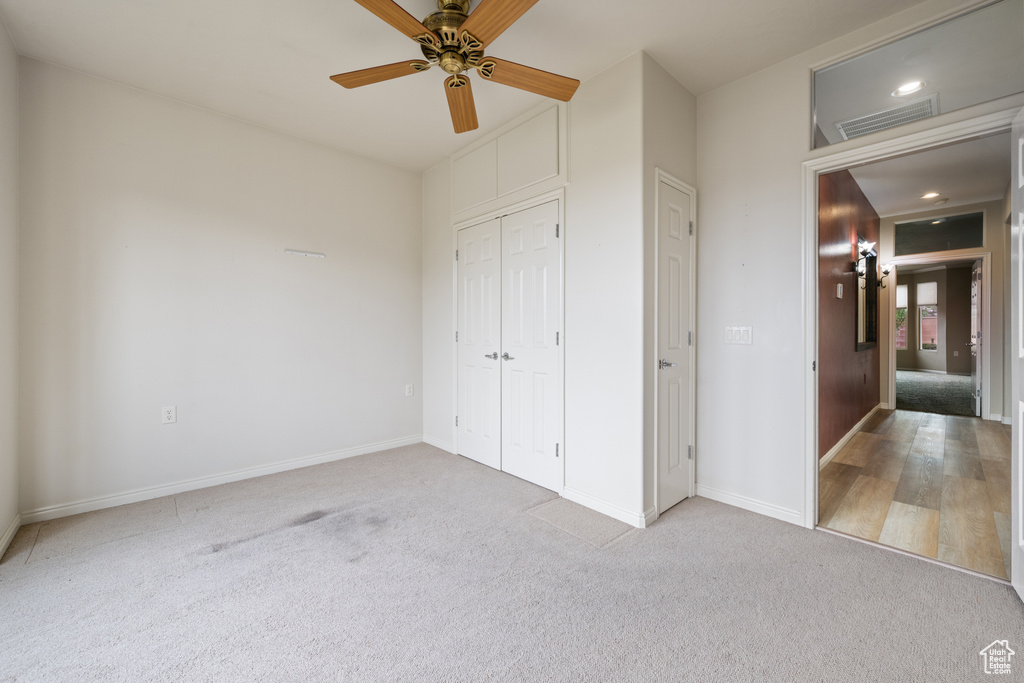 Unfurnished bedroom featuring carpet, a closet, ceiling fan, and recessed lighting