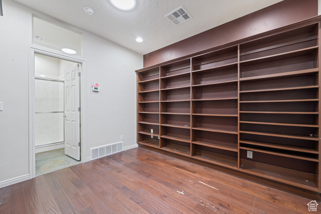 Unfurnished room featuring wood finished floors, recessed lighting, and a smoke detector