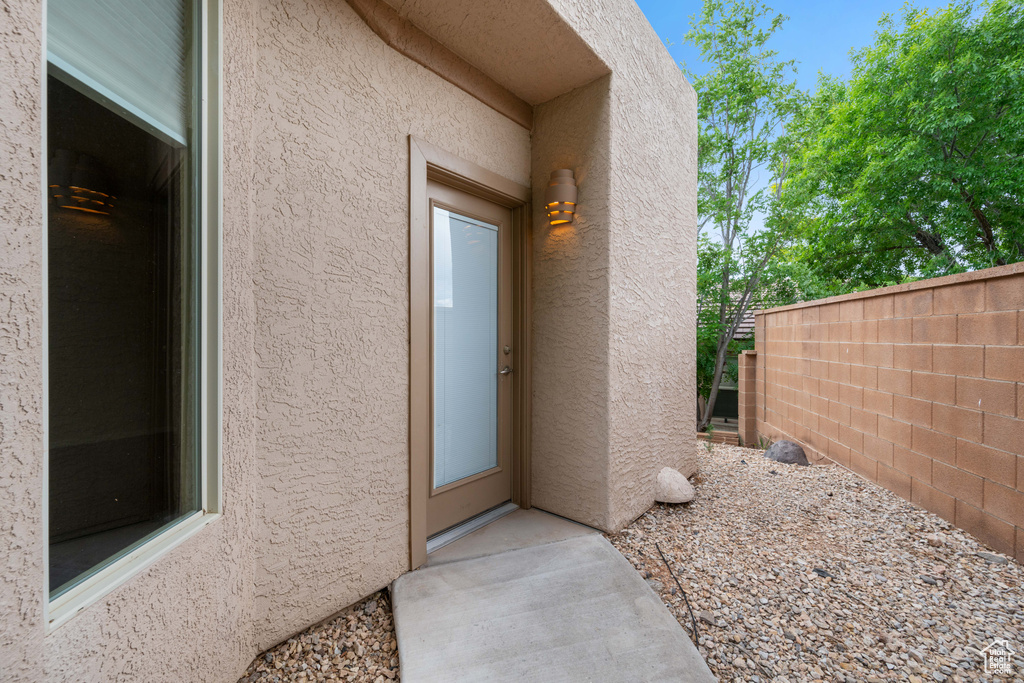 View of exterior entry with stucco siding