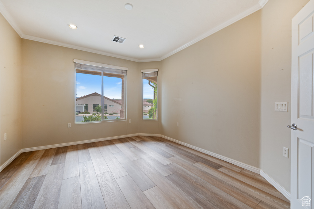 Spare room with light wood-style flooring, crown molding, and recessed lighting