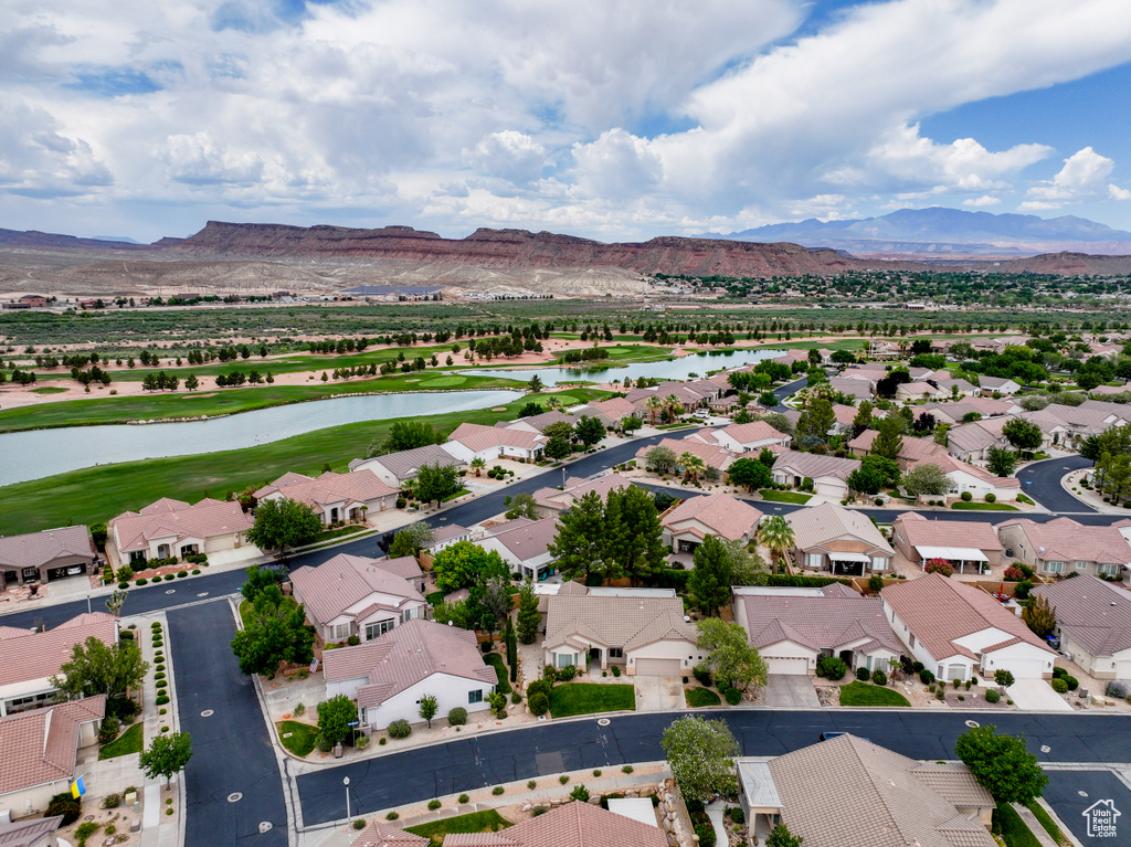 Aerial view of residential area with a water and mountain view and a local golf course