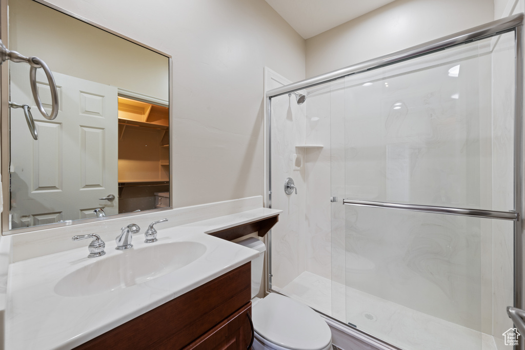 Bathroom with a shower stall and vanity