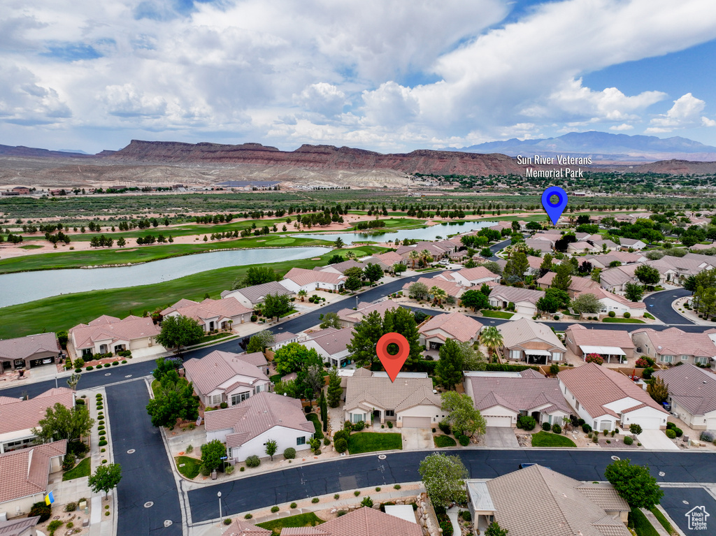 Aerial perspective of suburban area with a water and mountain view and a local golf course