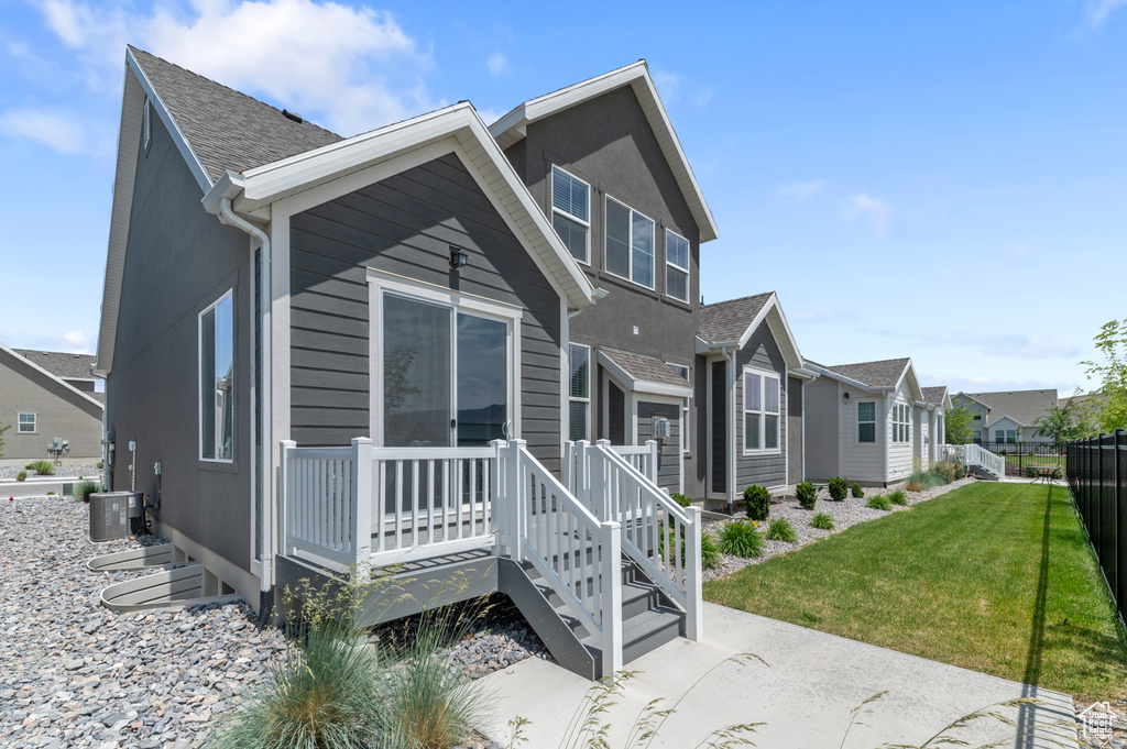 Rear view of property with a residential view, a wooden deck, and a shingled roof