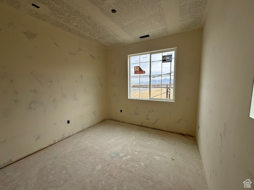 Unfurnished room with a textured ceiling