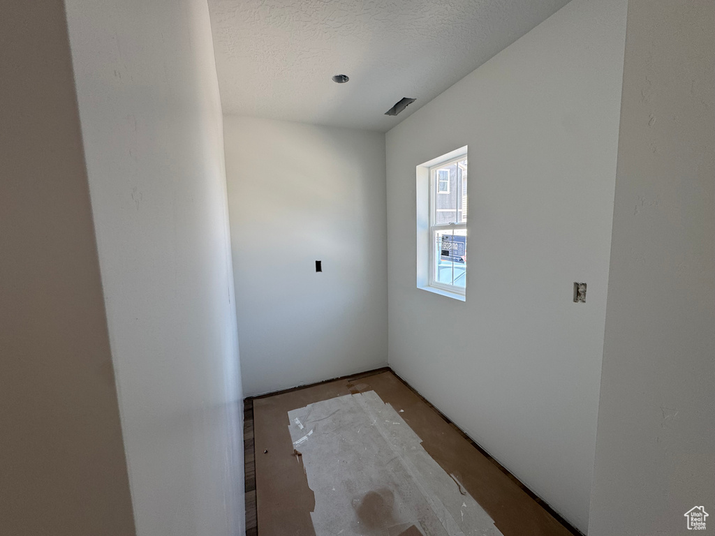 Empty room with a textured ceiling