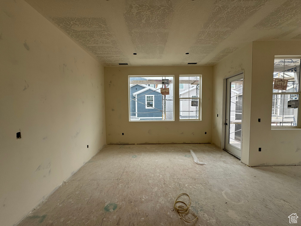 Spare room featuring plenty of natural light and a textured ceiling