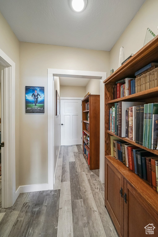 Hallway featuring wood finished floors and baseboards