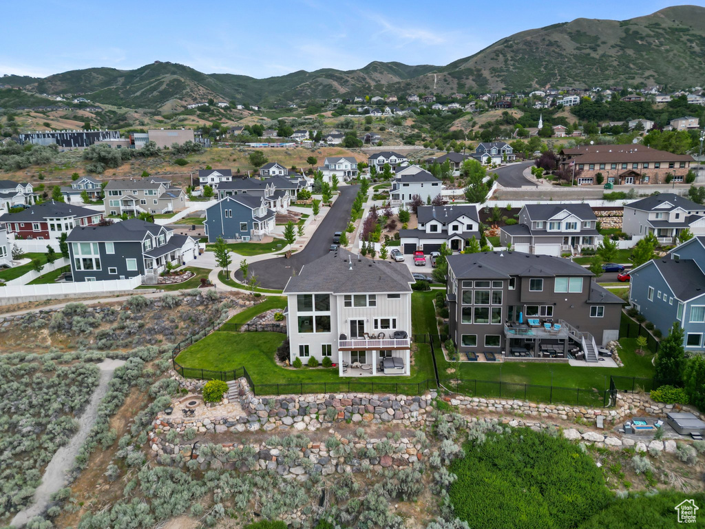 Aerial view of property\'s location with a mountain backdrop and nearby suburban area