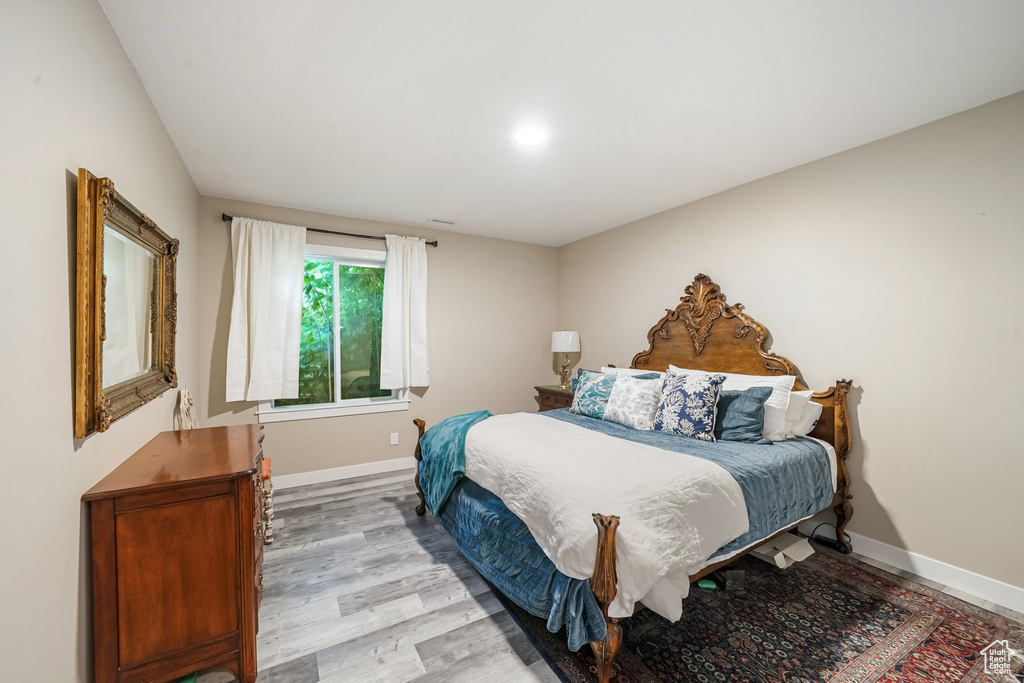 Bedroom featuring light wood finished floors and baseboards
