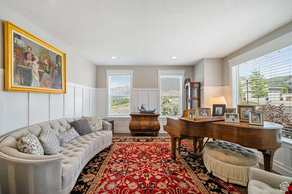Home office featuring plenty of natural light, a wainscoted wall, and a decorative wall