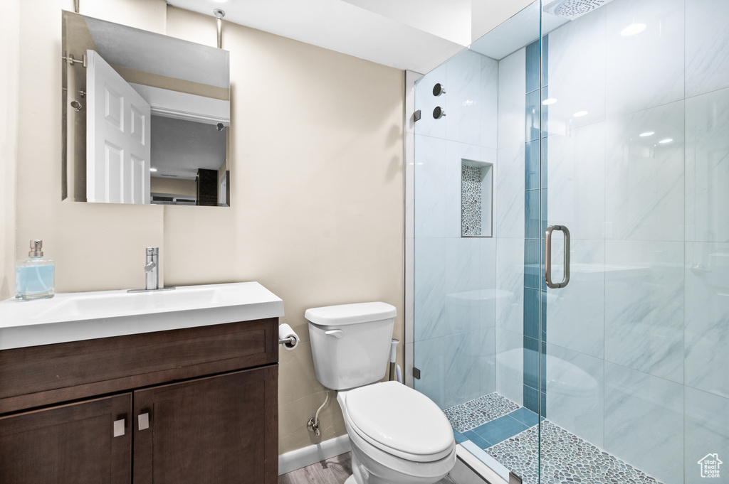 Bathroom featuring vanity, a stall shower, and baseboard heating