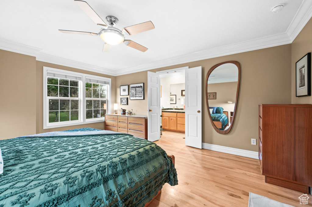 Bedroom with crown molding, light wood-style floors, ceiling fan, and connected bathroom