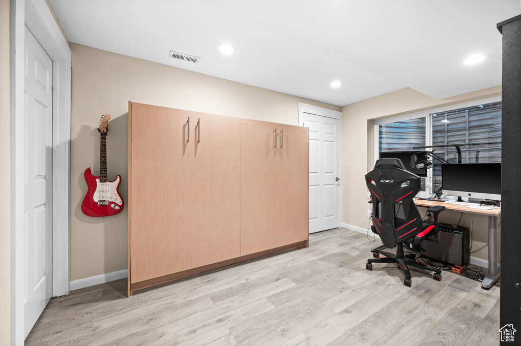 Office area featuring light wood-type flooring and recessed lighting