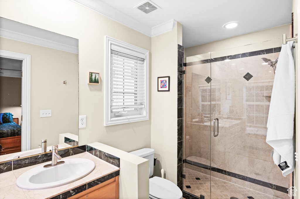 Full bathroom with vanity, a shower stall, crown molding, and recessed lighting
