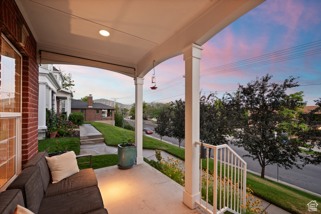 Patio terrace at dusk featuring covered porch