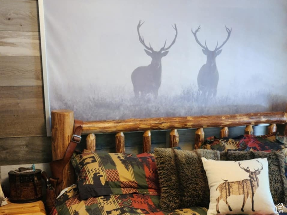 Carpeted bedroom with wood walls and a textured ceiling