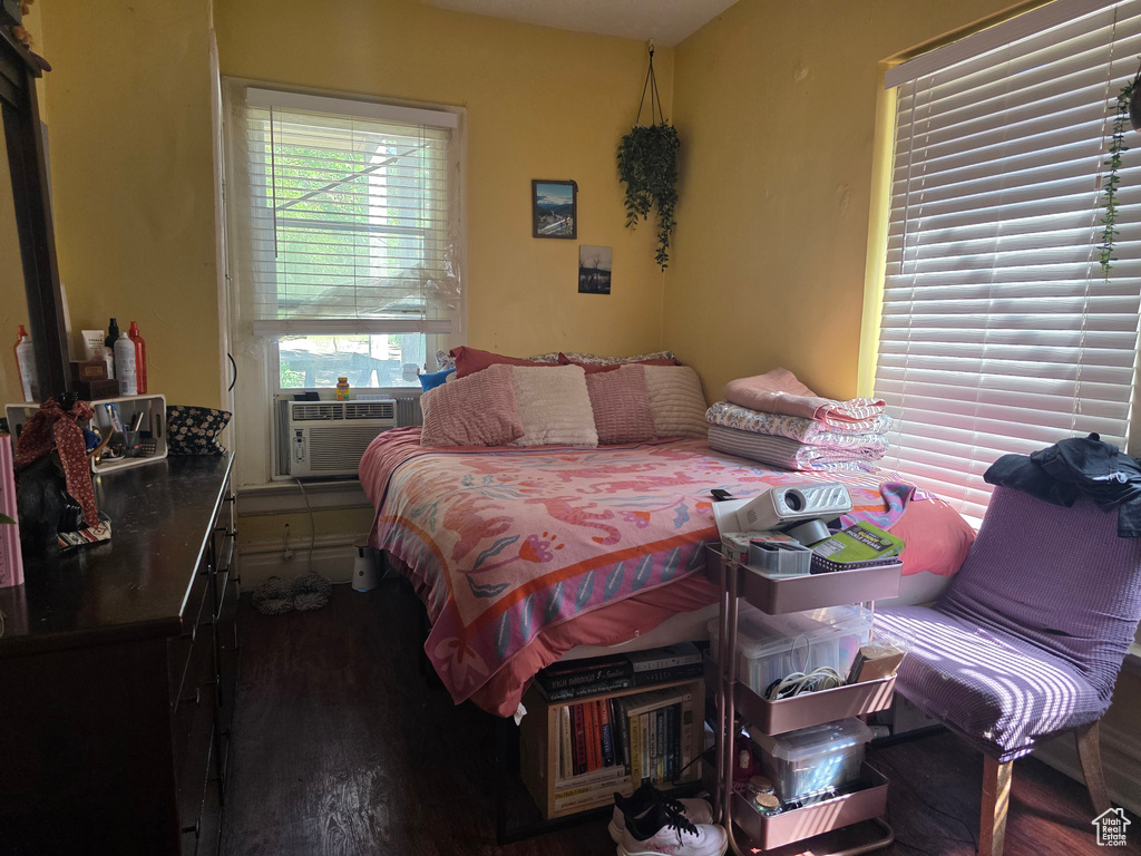 Bedroom featuring cooling unit and wood finished floors