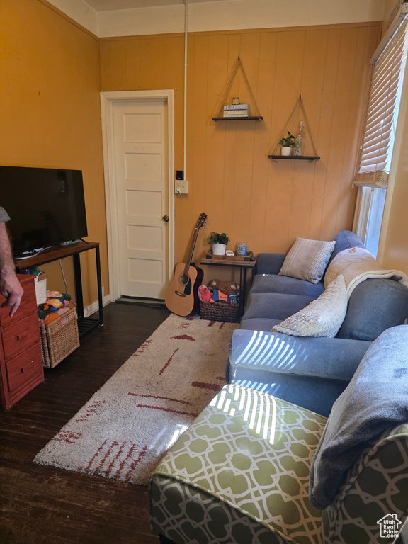 Living area with dark wood finished floors and baseboards