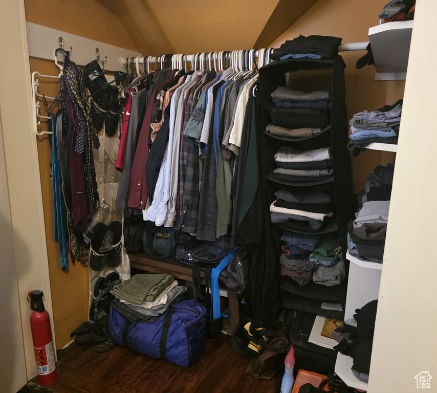 Walk in closet with wood finished floors